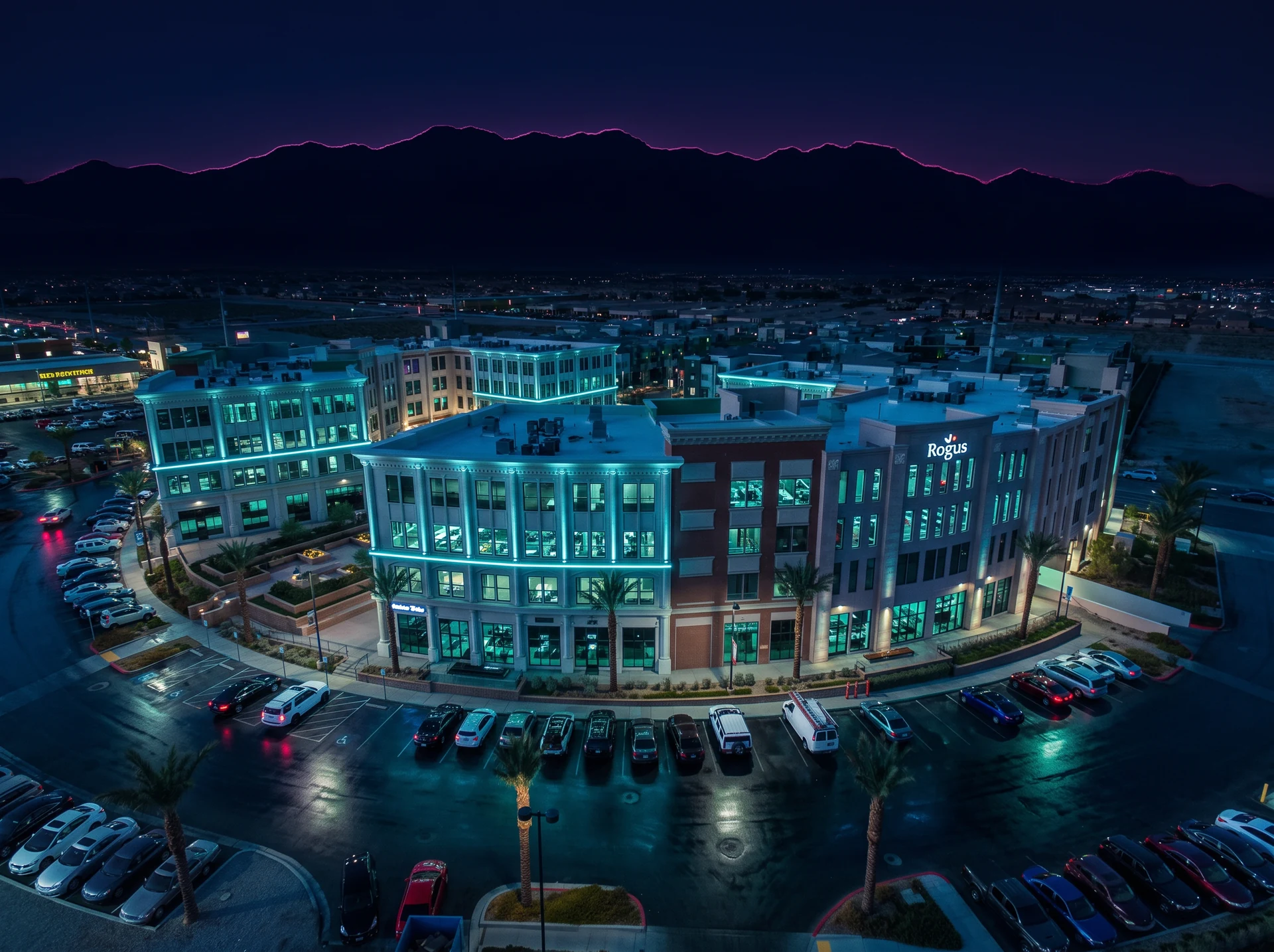 A modern low-rise office building in Summerlin, Las Vegas at night with desert landscaping